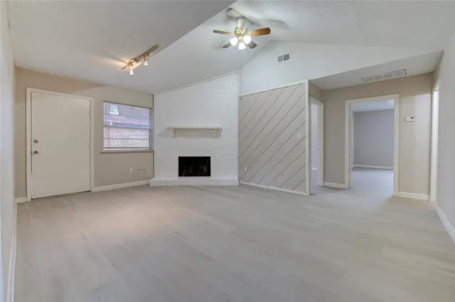 a view of empty room with a fireplace