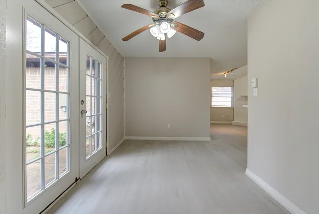 a view of a livingroom with a ceiling fan and window