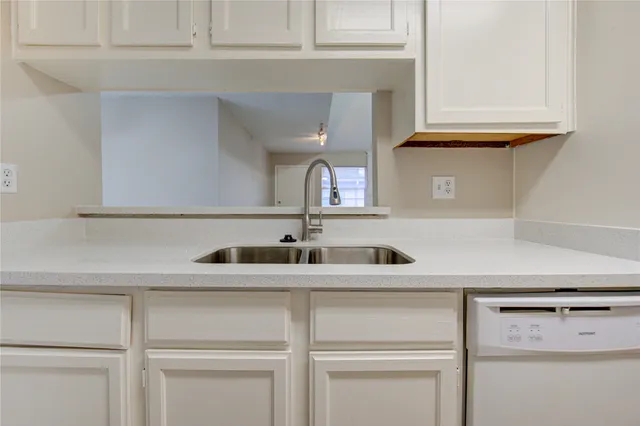 a kitchen with a sink and cabinets