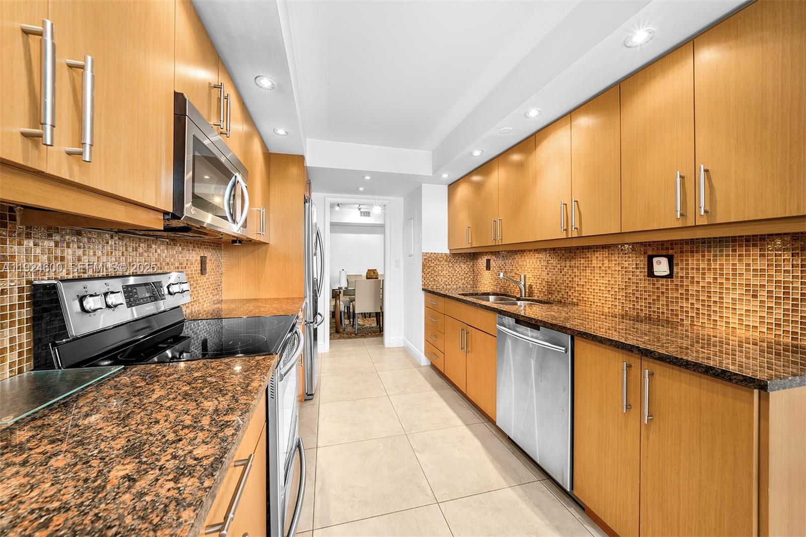 4000 Towerside Terrace, Unit 705 Miami, FL 33138 - Photo 14 of 42 a kitchen with stainless steel appliances granite countertop a sink and cabinets
