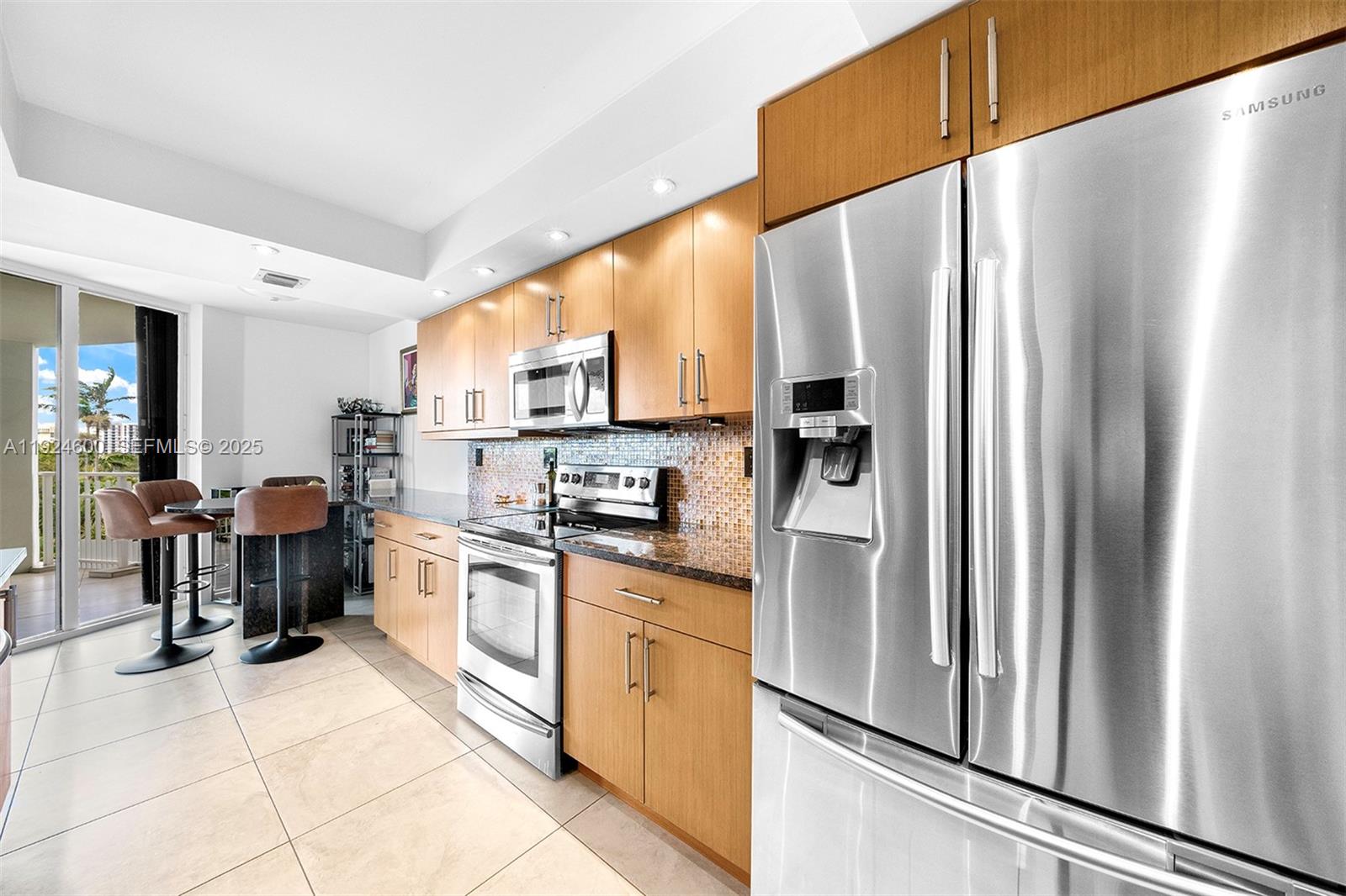 4000 Towerside Terrace, Unit 705 Miami, FL 33138 - Photo 16 of 42 a kitchen with stainless steel appliances a refrigerator sink and microwave