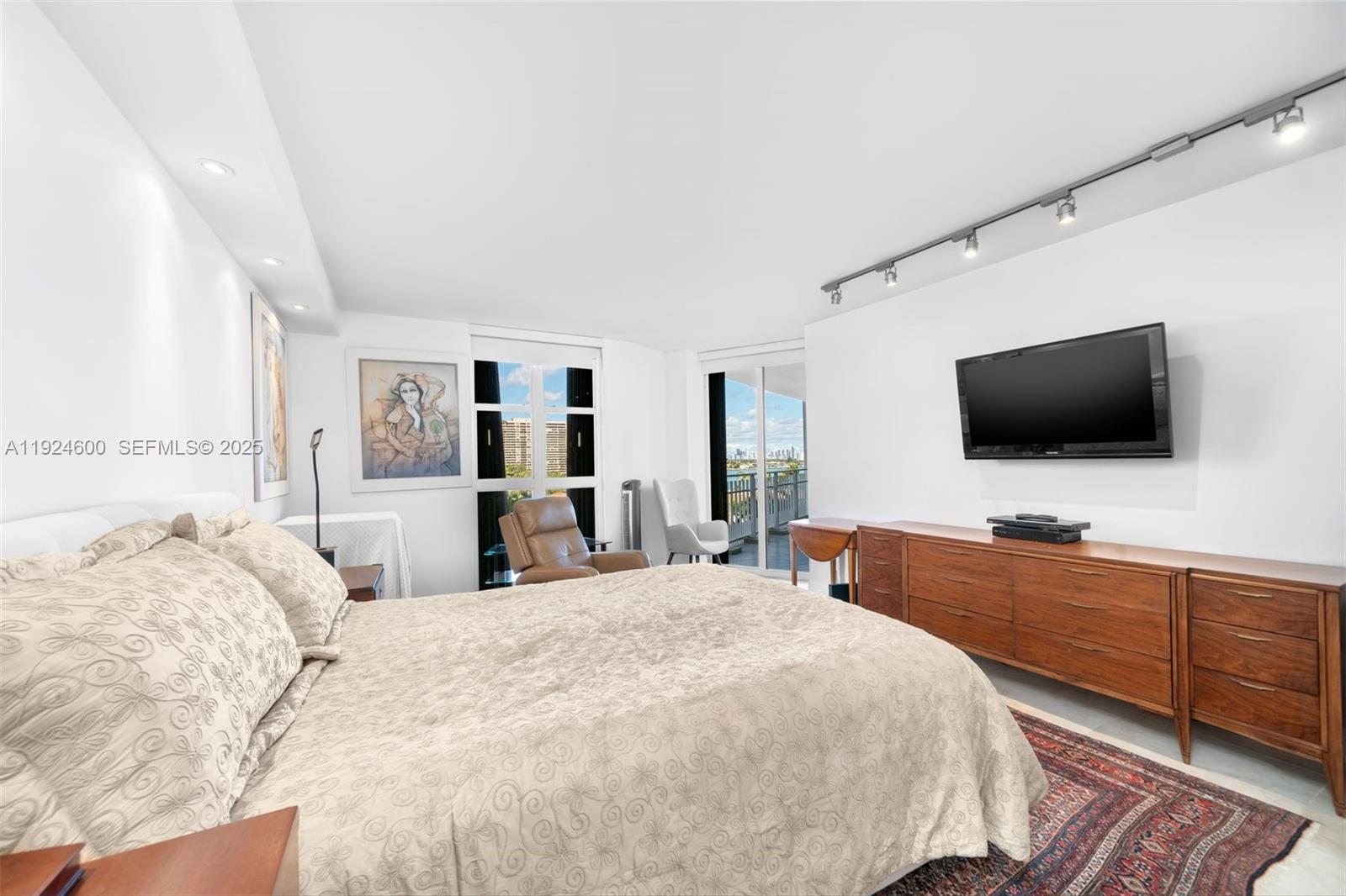 4000 Towerside Terrace, Unit 705 Miami, FL 33138 - Photo 21 of 42 a large bedroom with a bed and a flat screen tv