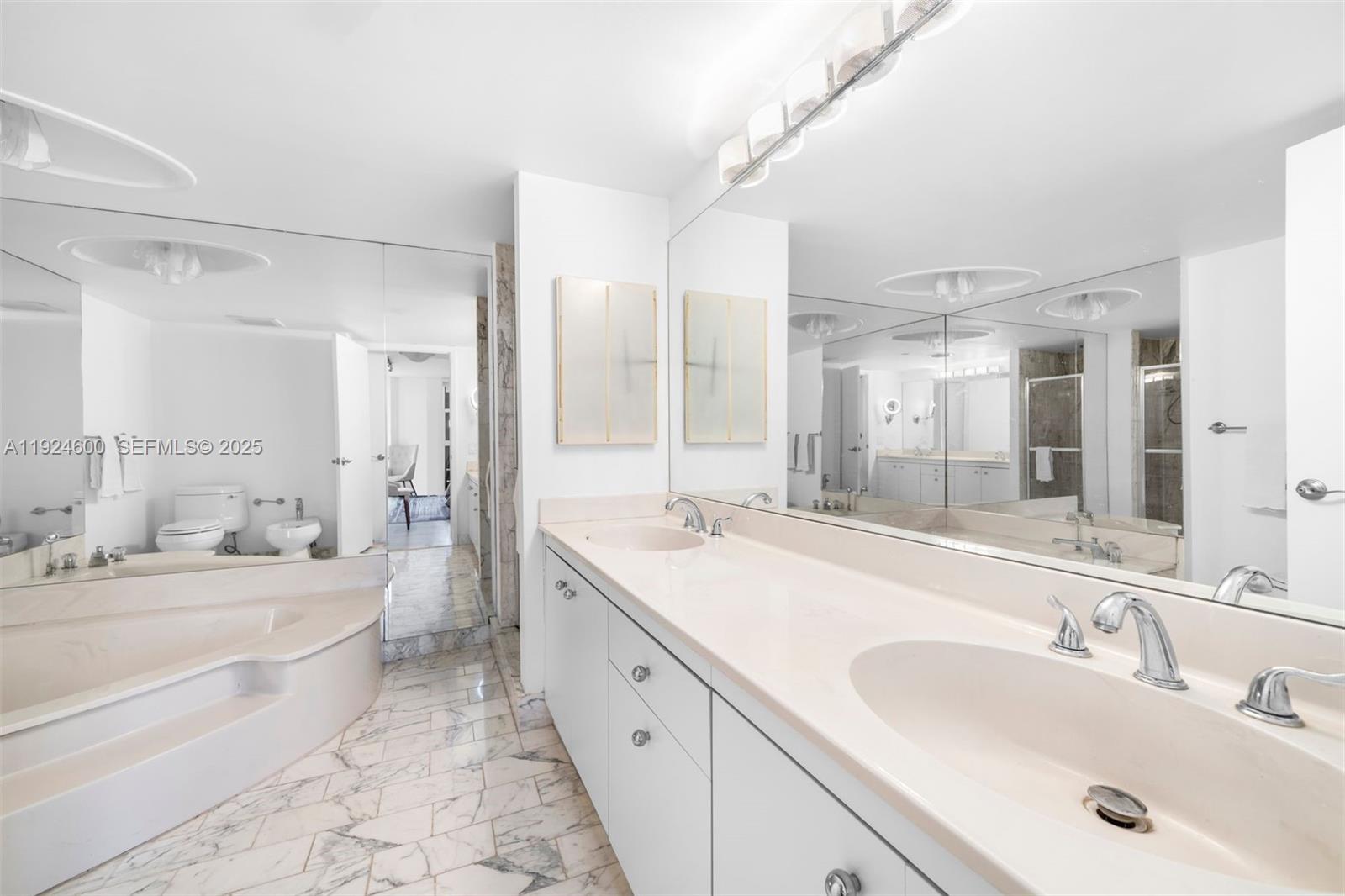 4000 Towerside Terrace, Unit 705 Miami, FL 33138 - Photo 22 of 42 a spacious bathroom with a double vanity sink mirror double and bathtub
