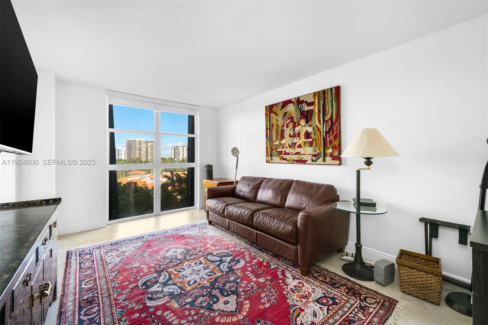 4000 Towerside Terrace, Unit 705 Miami, FL 33138 - Photo 24 of 42 a living room with furniture and a flat screen tv