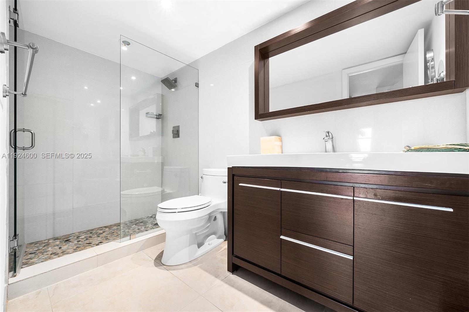 4000 Towerside Terrace, Unit 705 Miami, FL 33138 - Photo 25 of 42 a bathroom with a toilet a sink and shower