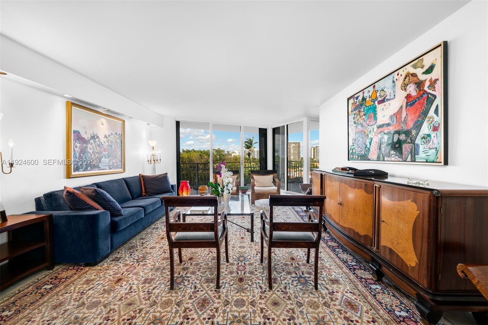 4000 Towerside Terrace, Unit 705 Miami, FL 33138 - Photo 4 of 42 a living room with furniture a flat screen tv and a refrigerator