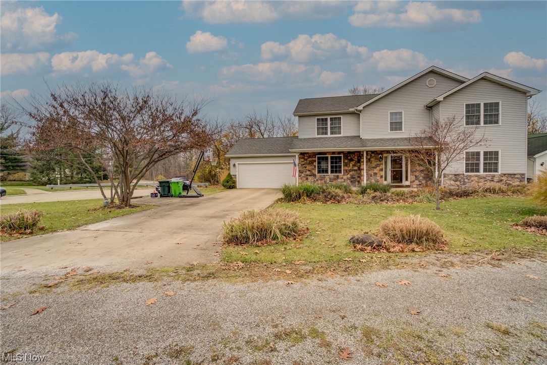 View of front property with a front yard and a garage