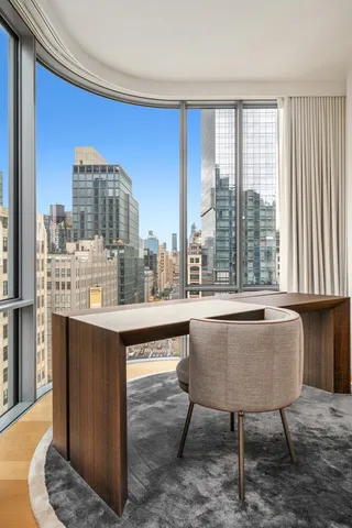 a bedroom with a bed and large window