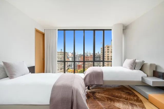 a spacious bathroom with a double vanity sink a mirror and a bathtub