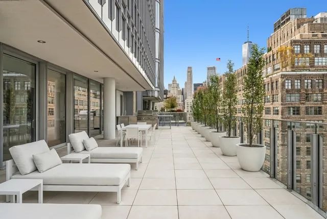 a view of a patio with table and chairs and potted plants