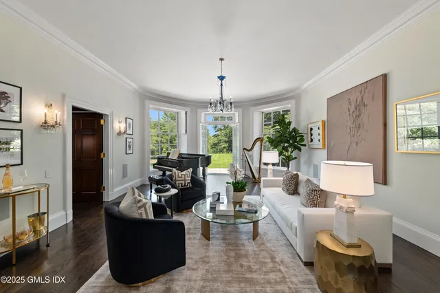 a living room with furniture and a chandelier