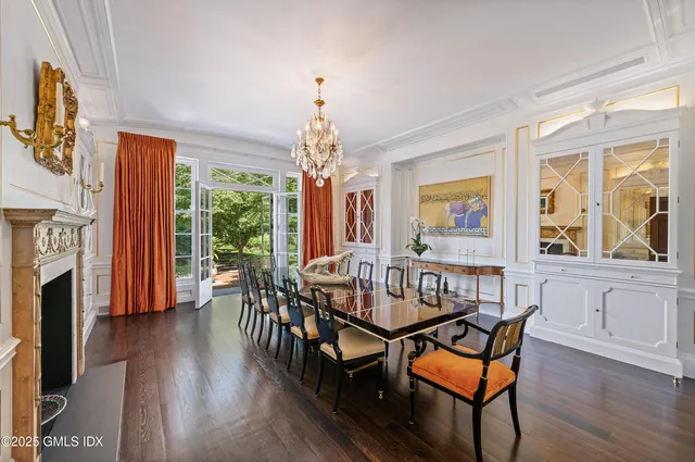 a living room with furniture a fireplace and a large window