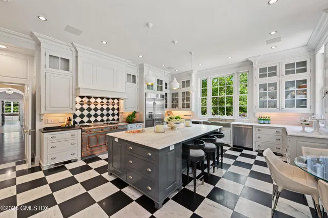 a kitchen with a sink a stove a dining table and chairs