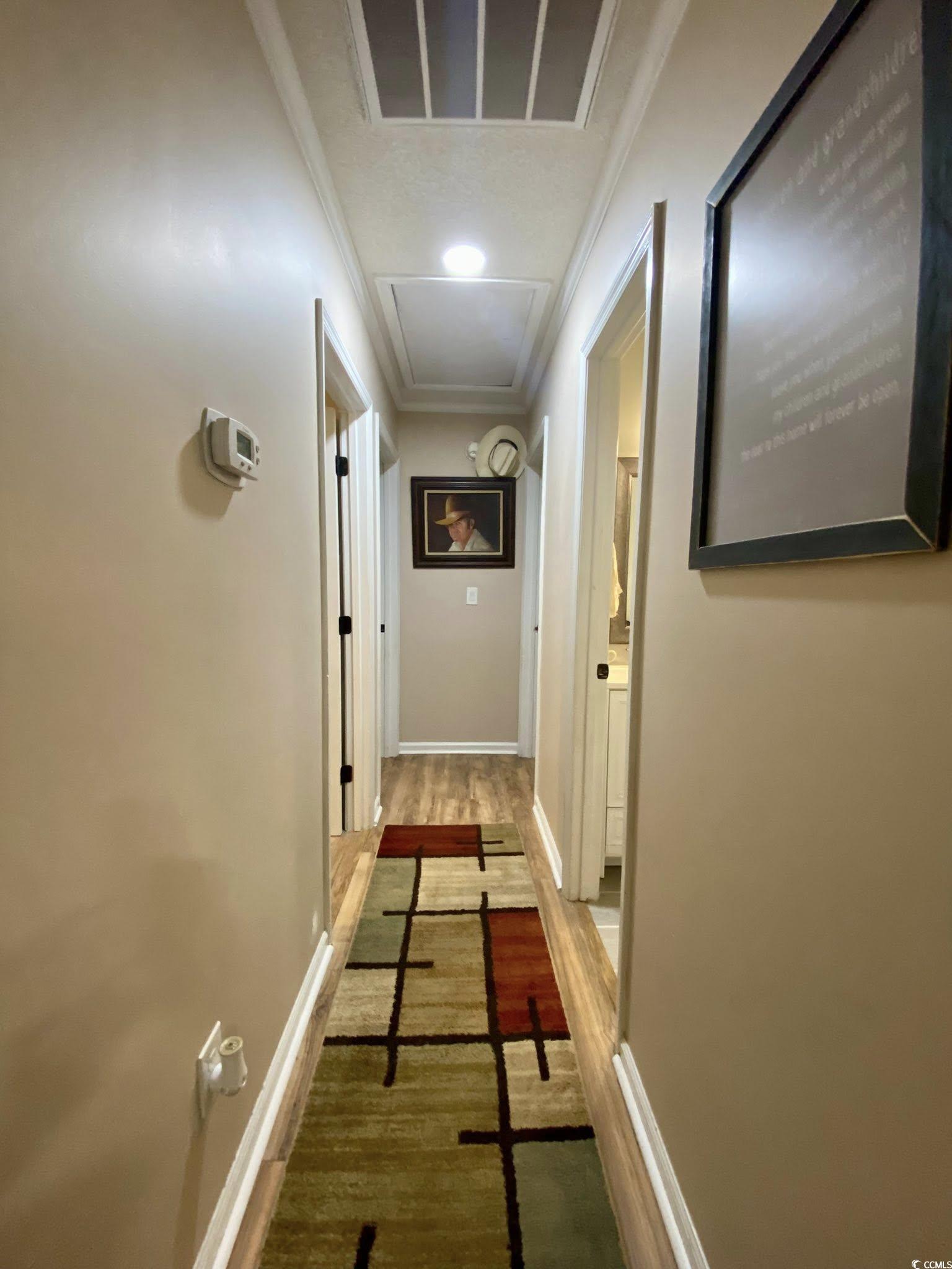 512 South Hazel Avenue Andrews, SC 29510 - Photo 7 of 15 Hallway featuring crown molding and wood finished