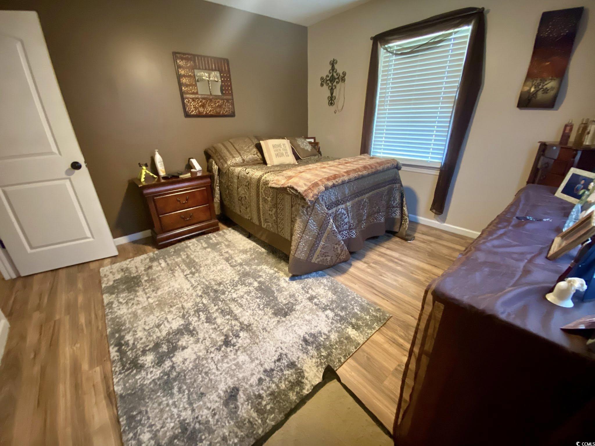 512 South Hazel Avenue Andrews, SC 29510 - Photo 9 of 15 Bedroom featuring wood finished floors and baseboa