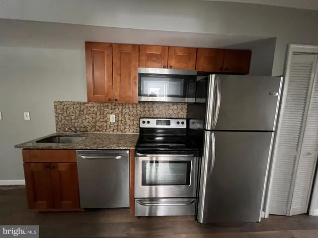 a kitchen with a refrigerator stove and microwave