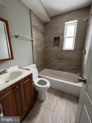 a bathroom with a toilet a sink and bathtub