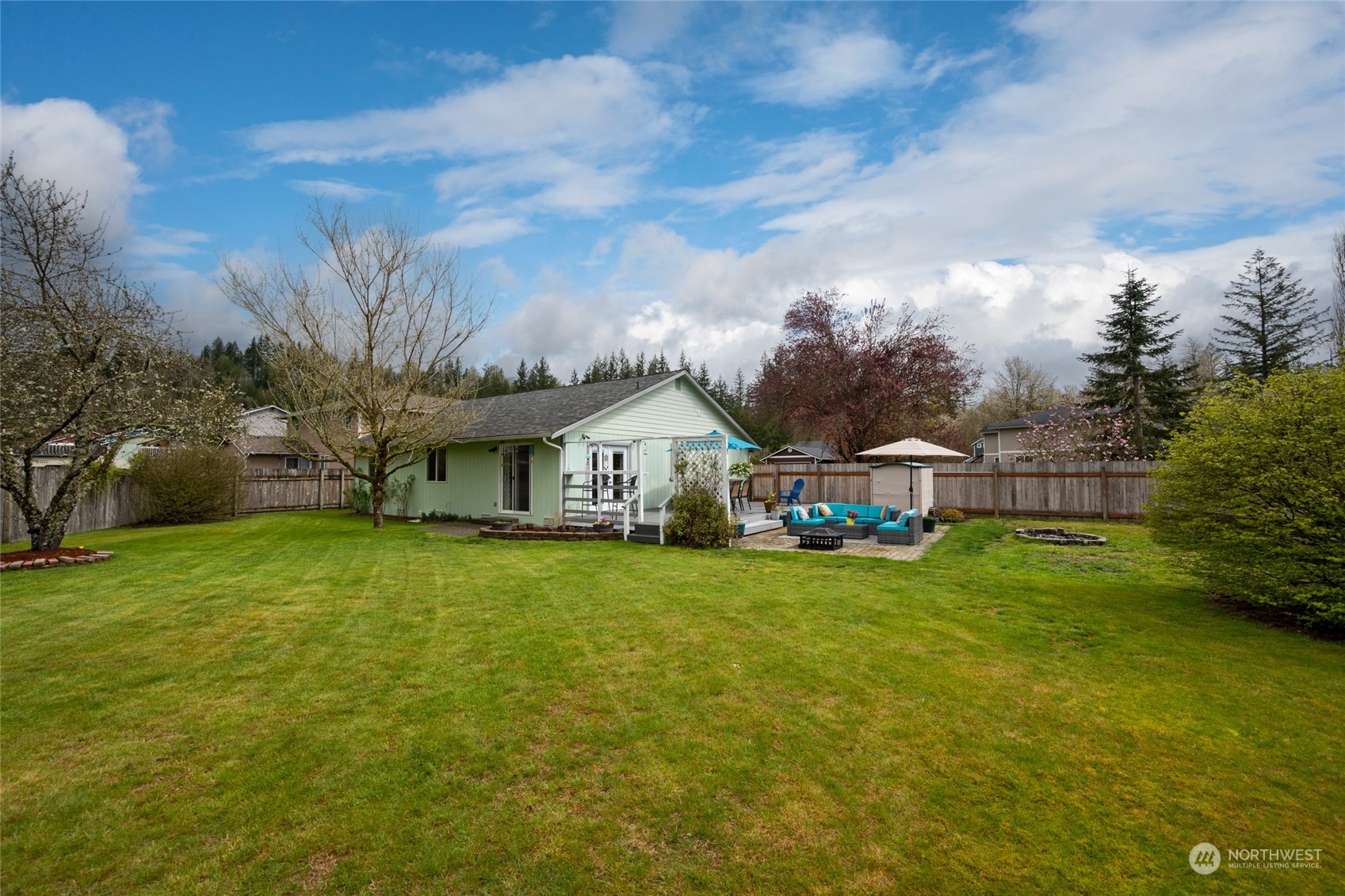 1703 Gohr Road Sultan, WA 98294 - Photo 12 of 16 a view of a house with a big yard and large trees