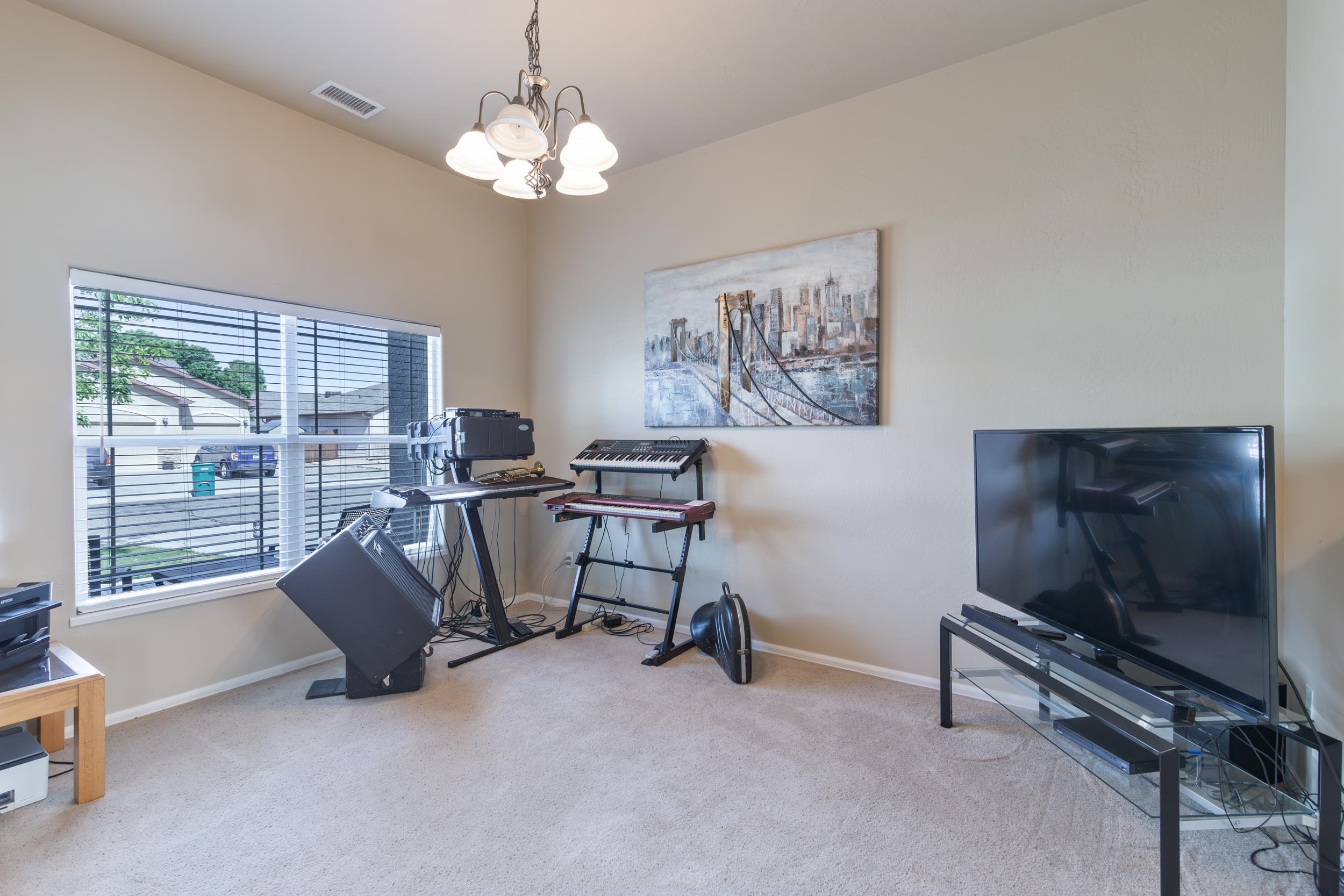 544 Hemlock Drive Fruita, CO 81521 - Photo 7 of 36 a living room with furniture a flat screen tv and a large window