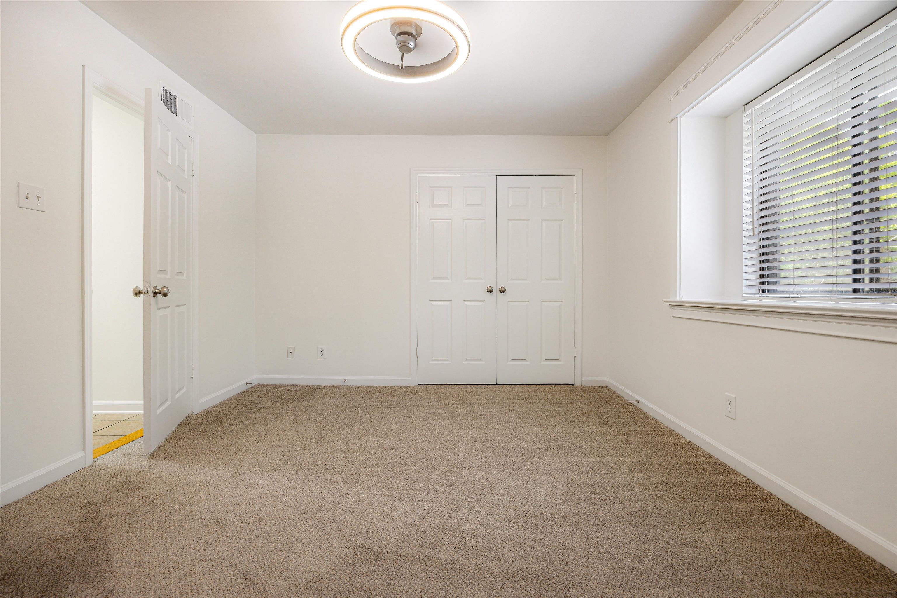 1847 Gray Ridge Cove, Unit 2 Germantown, TN 38138 - Photo 21 of 26 Unfurnished bedroom with carpet floors, baseboards, and a closet
