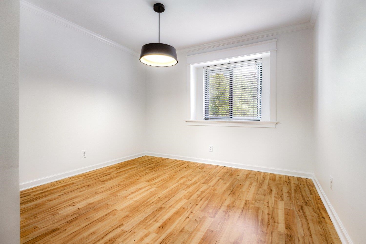 1847 Gray Ridge Cove, Unit 2 Germantown, TN 38138 - Photo 10 of 26 Unfurnished room with wood finished floors, crown molding, and baseboards