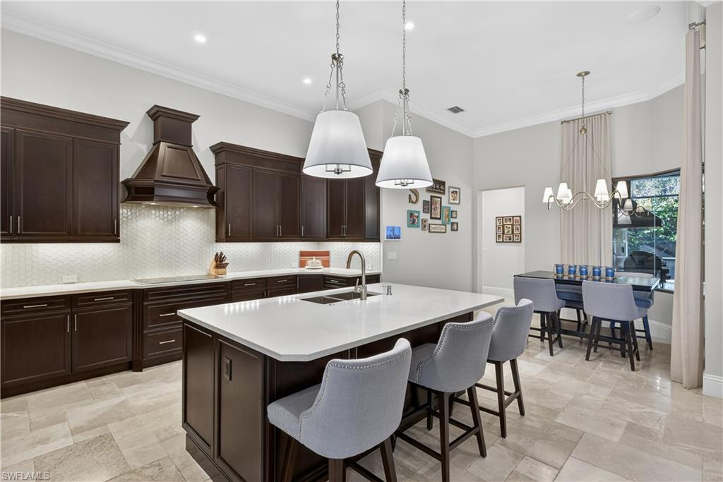 7405 Acorn Way Naples, FL 34119 - Photo 12 of 50 a kitchen with a table and chairs in it