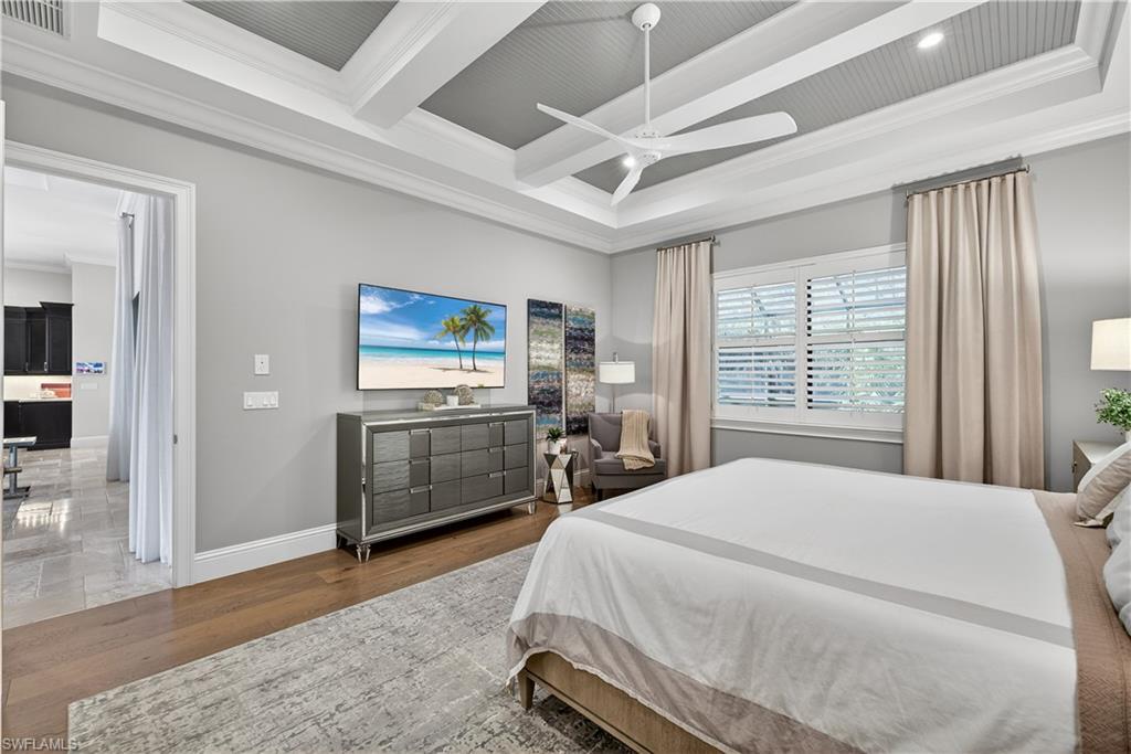 7405 Acorn Way Naples, FL 34119 - Photo 18 of 50 a bedroom with a bed and a dresser next to a window