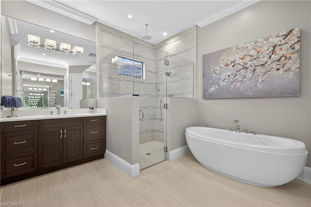 7405 Acorn Way Naples, FL 34119 - Photo 19 of 50 a bathroom with a double vanity sink mirror and bathtub