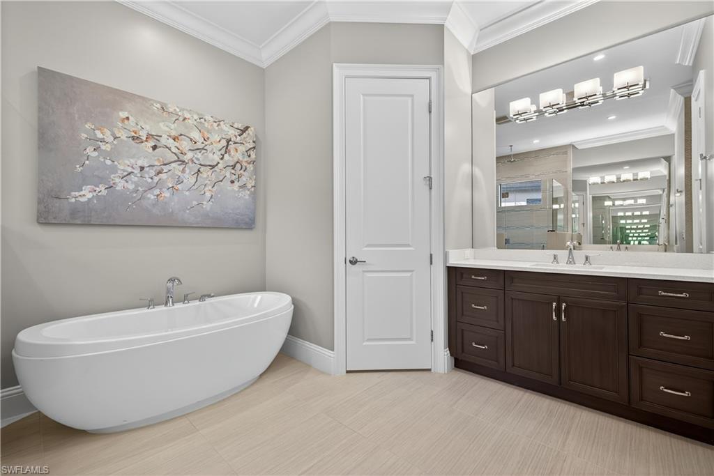 7405 Acorn Way Naples, FL 34119 - Photo 20 of 50 a bathroom with a bathtub and a sink