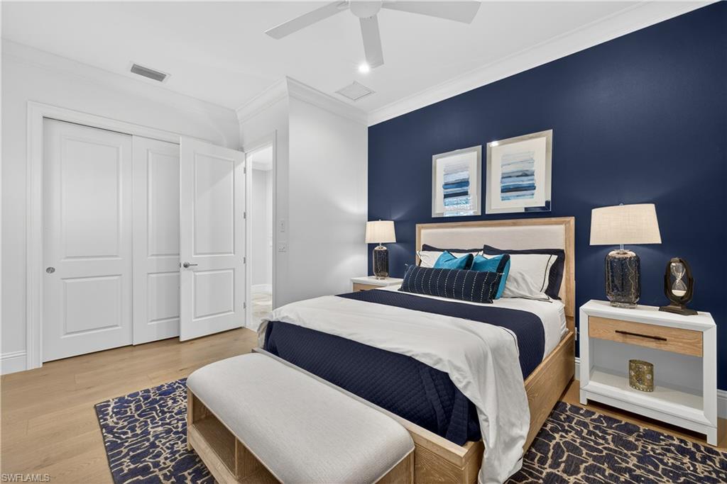 7405 Acorn Way Naples, FL 34119 - Photo 22 of 50 a bedroom with a bed and a lamp with the dresser