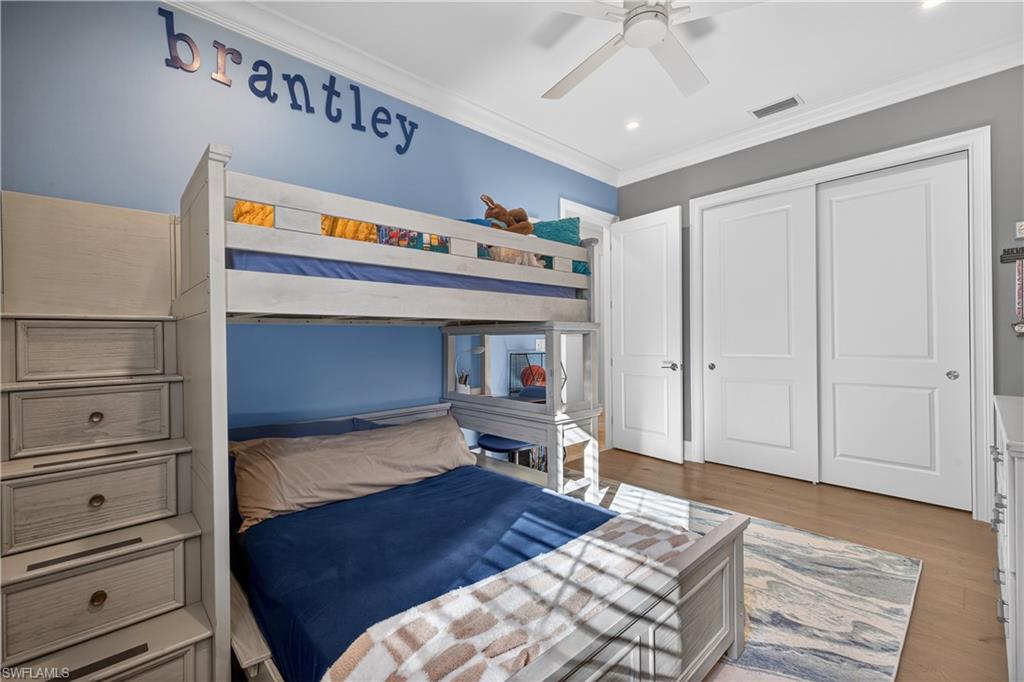 7405 Acorn Way Naples, FL 34119 - Photo 25 of 50 a bedroom with a bed and a ceiling fan