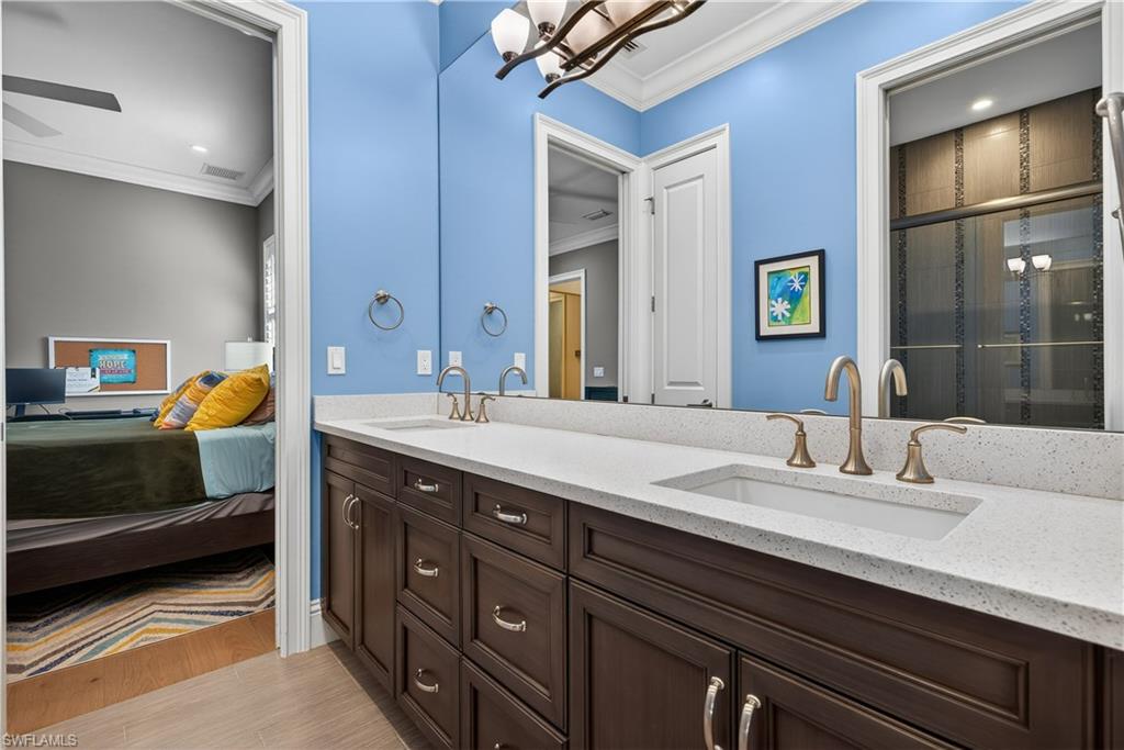 7405 Acorn Way Naples, FL 34119 - Photo 26 of 50 a bathroom with a sink double vanity and a mirror