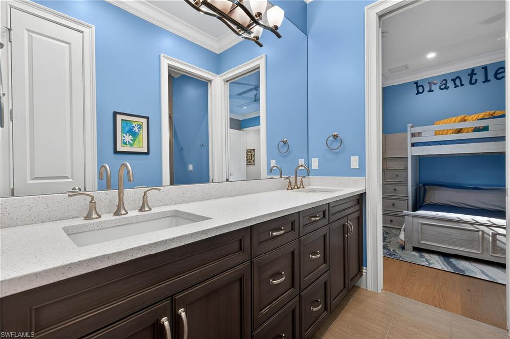 7405 Acorn Way Naples, FL 34119 - Photo 27 of 50 a bathroom with a sink double vanity and a mirror