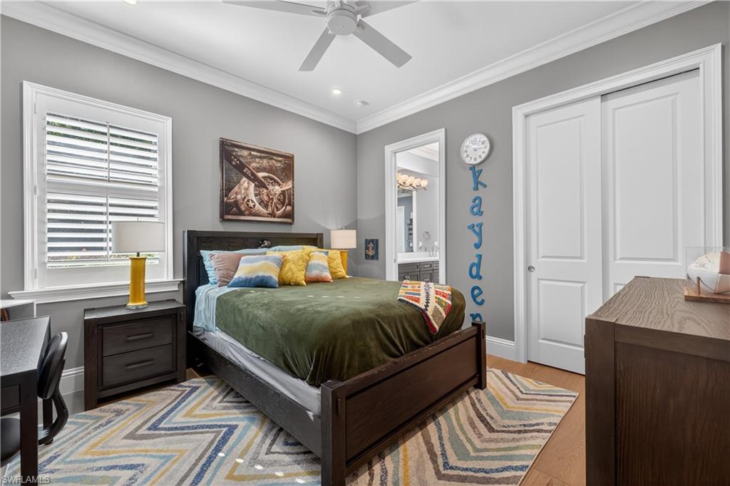 7405 Acorn Way Naples, FL 34119 - Photo 29 of 50 a spacious bedroom with a bed and a table