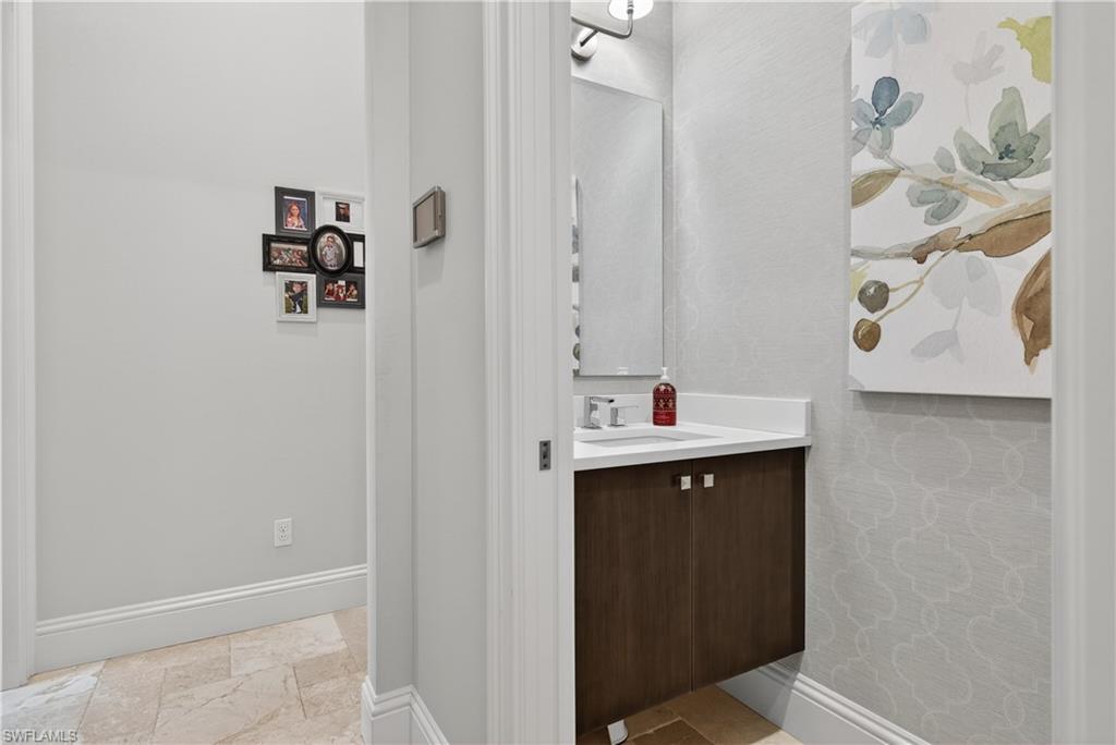 7405 Acorn Way Naples, FL 34119 - Photo 30 of 50 a bathroom with a sink and mirror