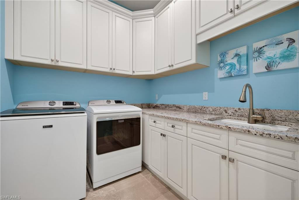 7405 Acorn Way Naples, FL 34119 - Photo 31 of 50 a kitchen with granite countertop white cabinets and white appliances