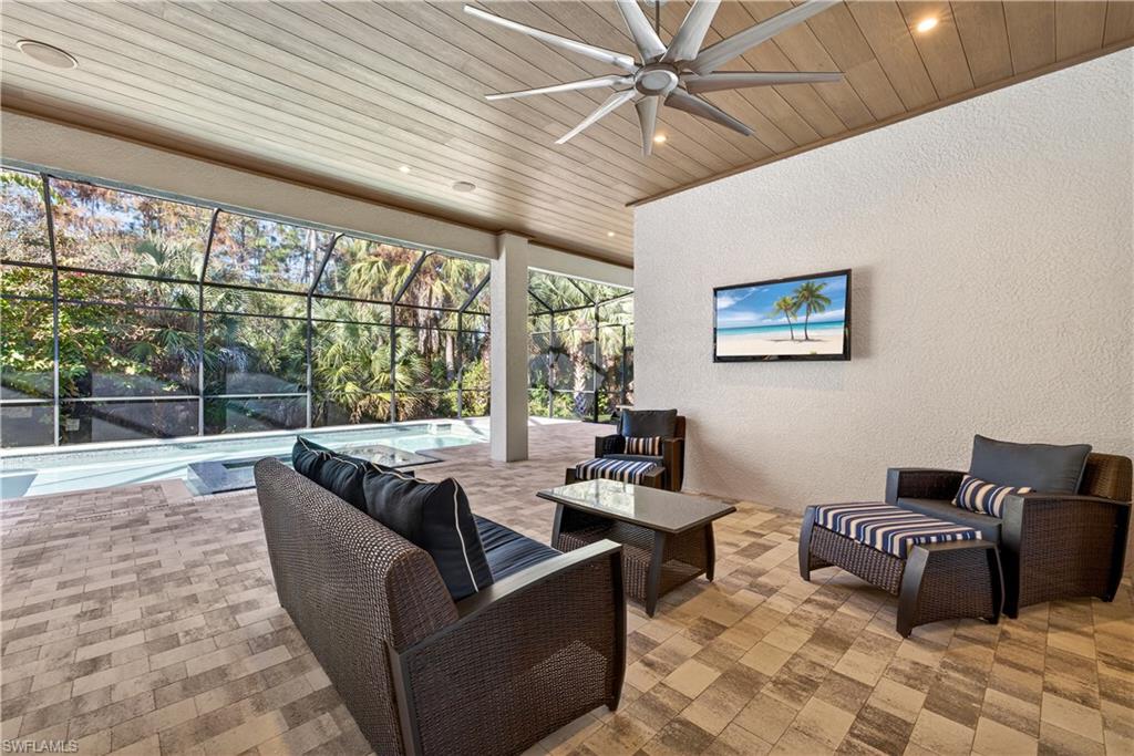 7405 Acorn Way Naples, FL 34119 - Photo 33 of 50 a living room with furniture and a large window