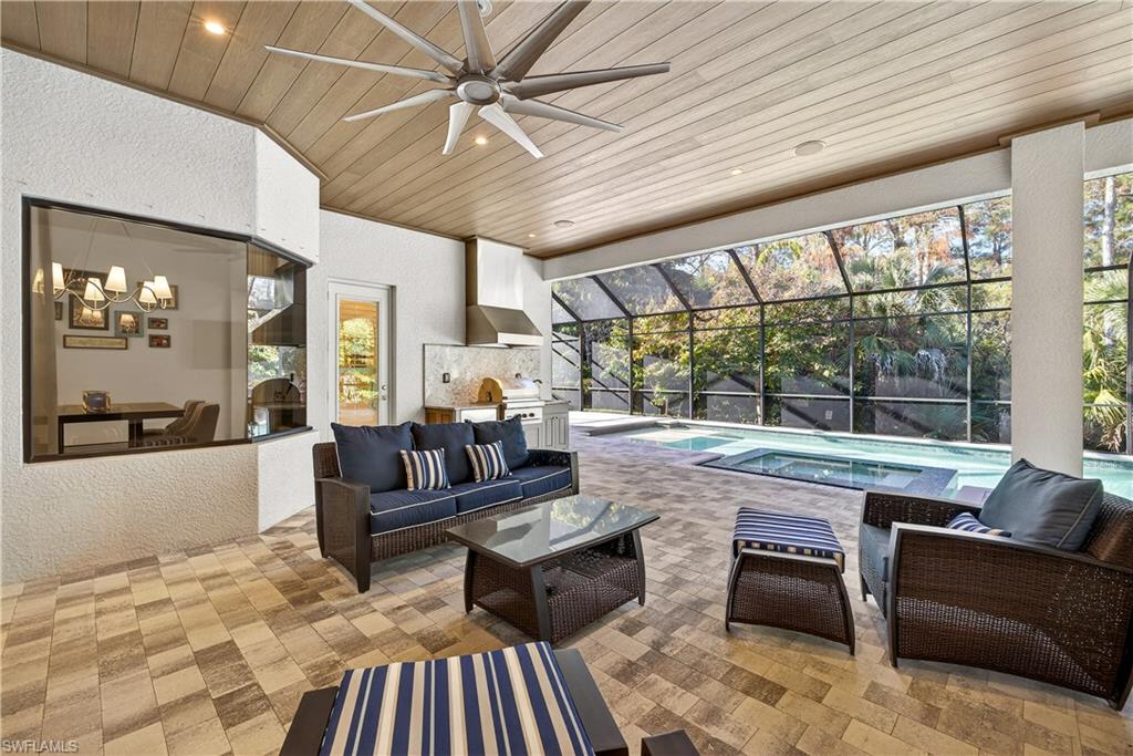 7405 Acorn Way Naples, FL 34119 - Photo 34 of 50 a living room with furniture and a large window