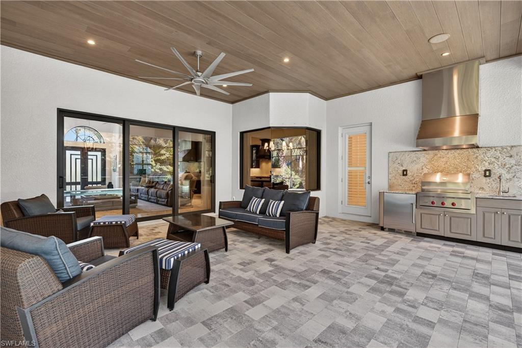 7405 Acorn Way Naples, FL 34119 - Photo 35 of 50 a living room with furniture and a large window