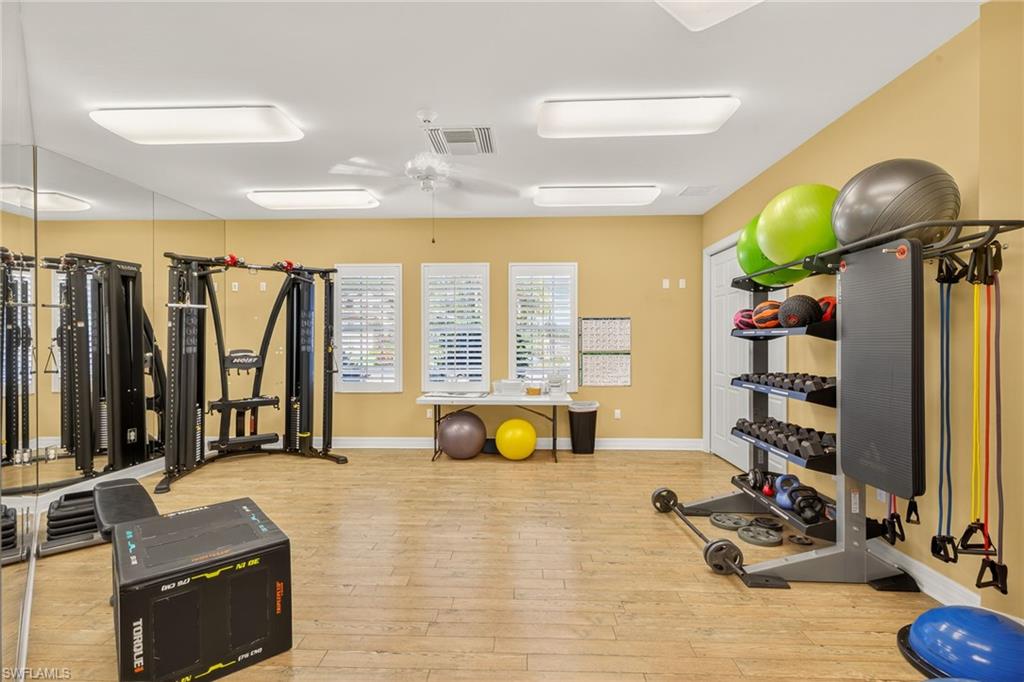 7405 Acorn Way Naples, FL 34119 - Photo 46 of 50 a living room with fireplace furniture and a flat screen tv