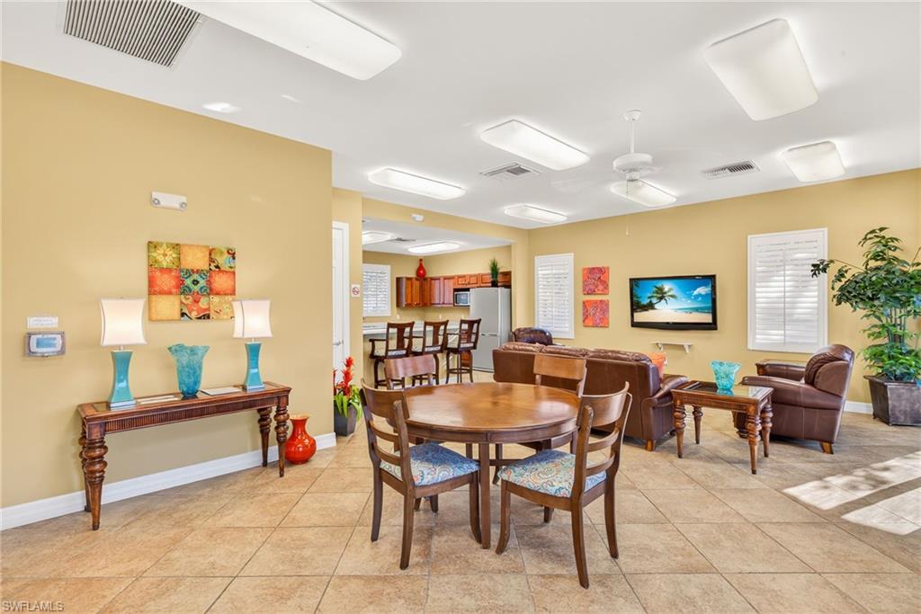 7405 Acorn Way Naples, FL 34119 - Photo 47 of 50 a dining room with furniture and a chandelier