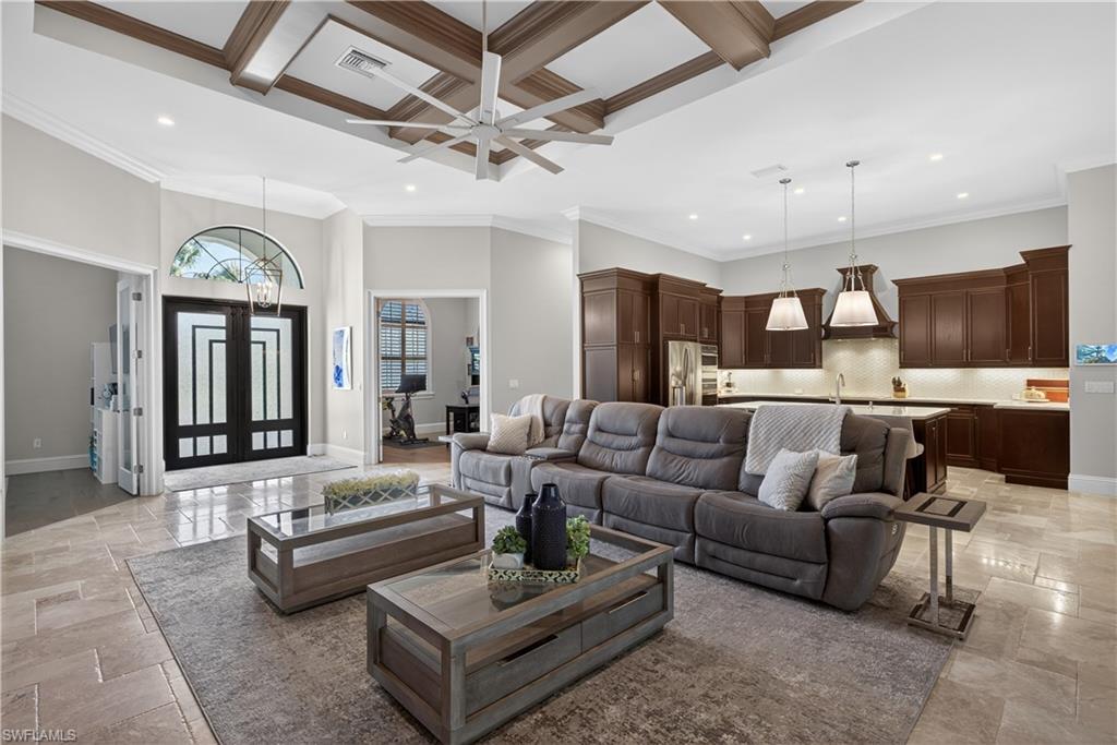 7405 Acorn Way Naples, FL 34119 - Photo 7 of 50 a living room with furniture kitchen view and a chandelier