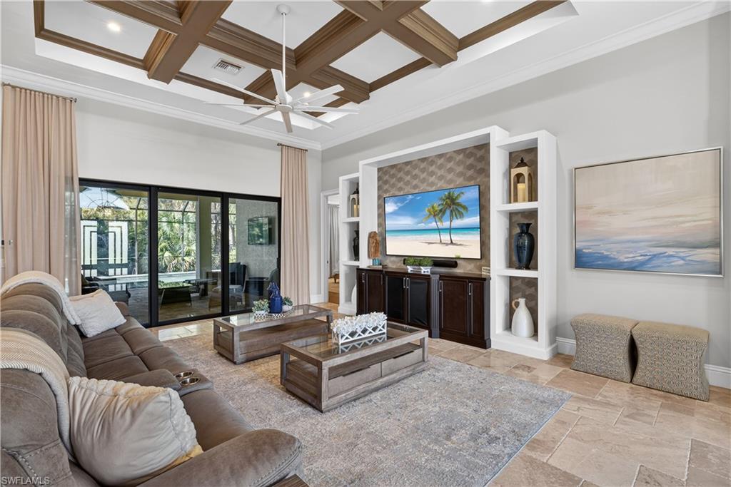 7405 Acorn Way Naples, FL 34119 - Photo 8 of 50 a living room with furniture and large windows