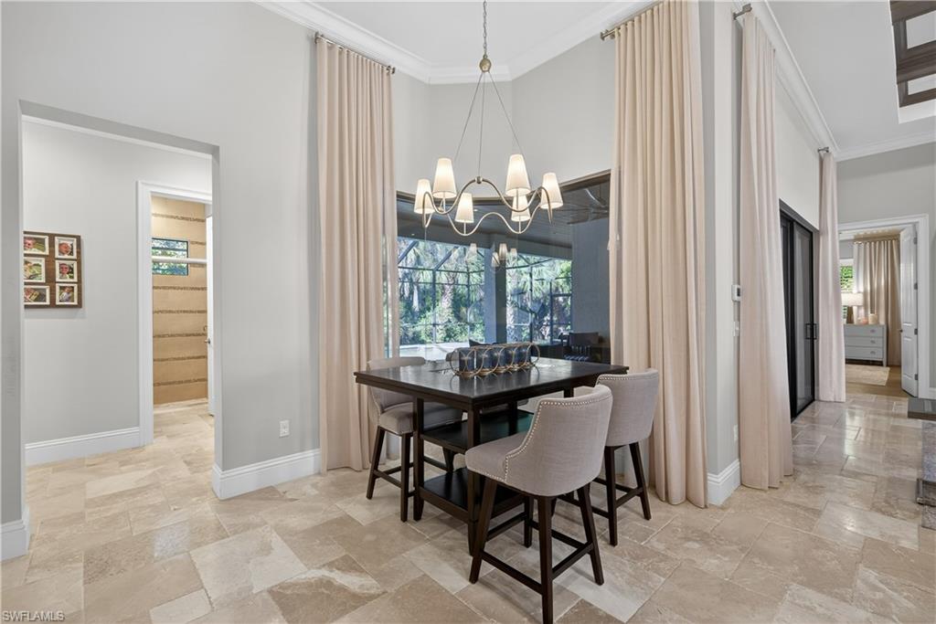 7405 Acorn Way Naples, FL 34119 - Photo 10 of 50 a view of a dining room with furniture and chandelier