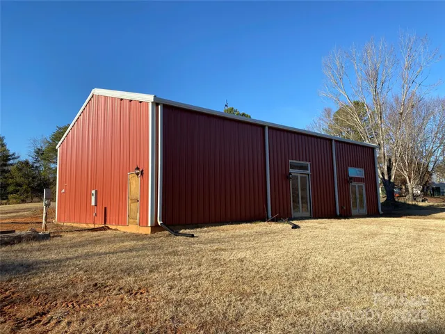 a view of garage with wooden fence