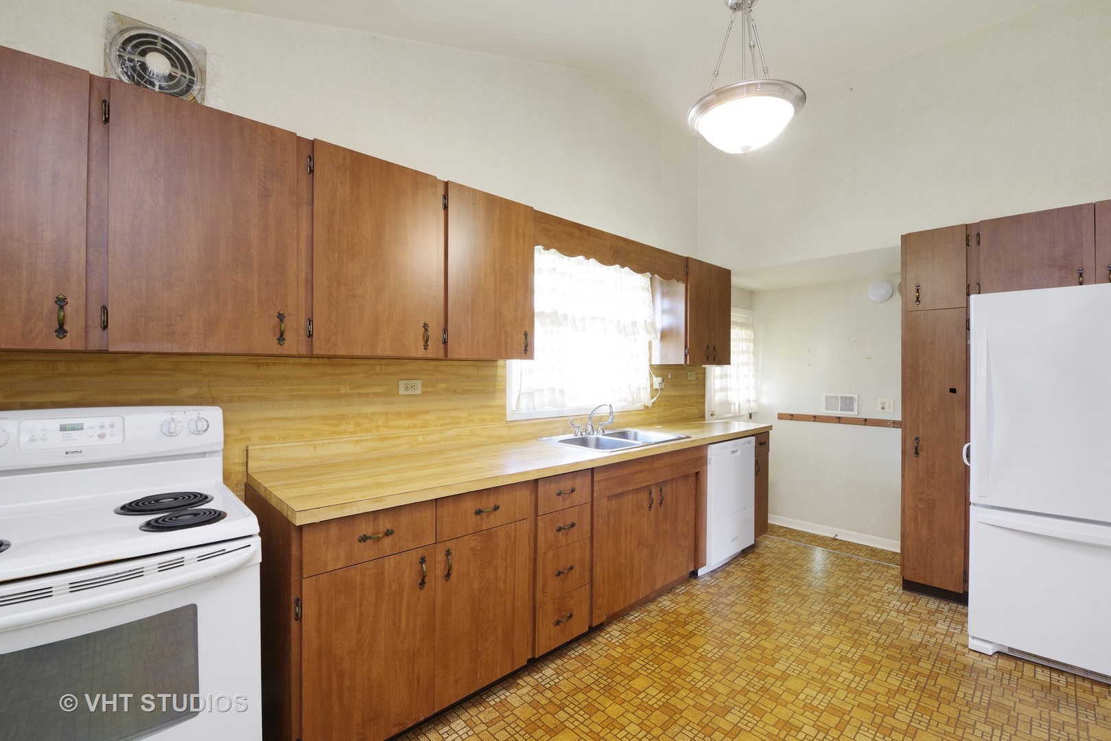 1034 Longaker Road Northbrook, IL 60062 - Photo 4 of 10 a kitchen with a sink a stove a refrigerator and a window