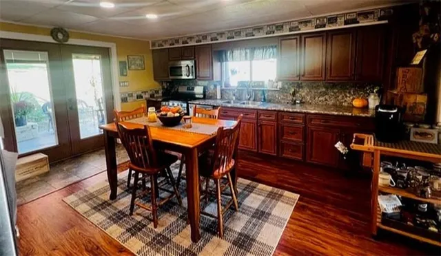 a view of a dining room with furniture and wooden floor