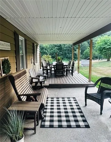a outdoor dining space with furniture and outdoor view