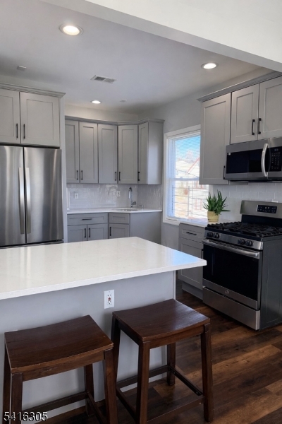 9 Oak Place Irvington, NJ 07111 - Photo 8 of 15 a kitchen with a refrigerator a stove a sink and a cabinets