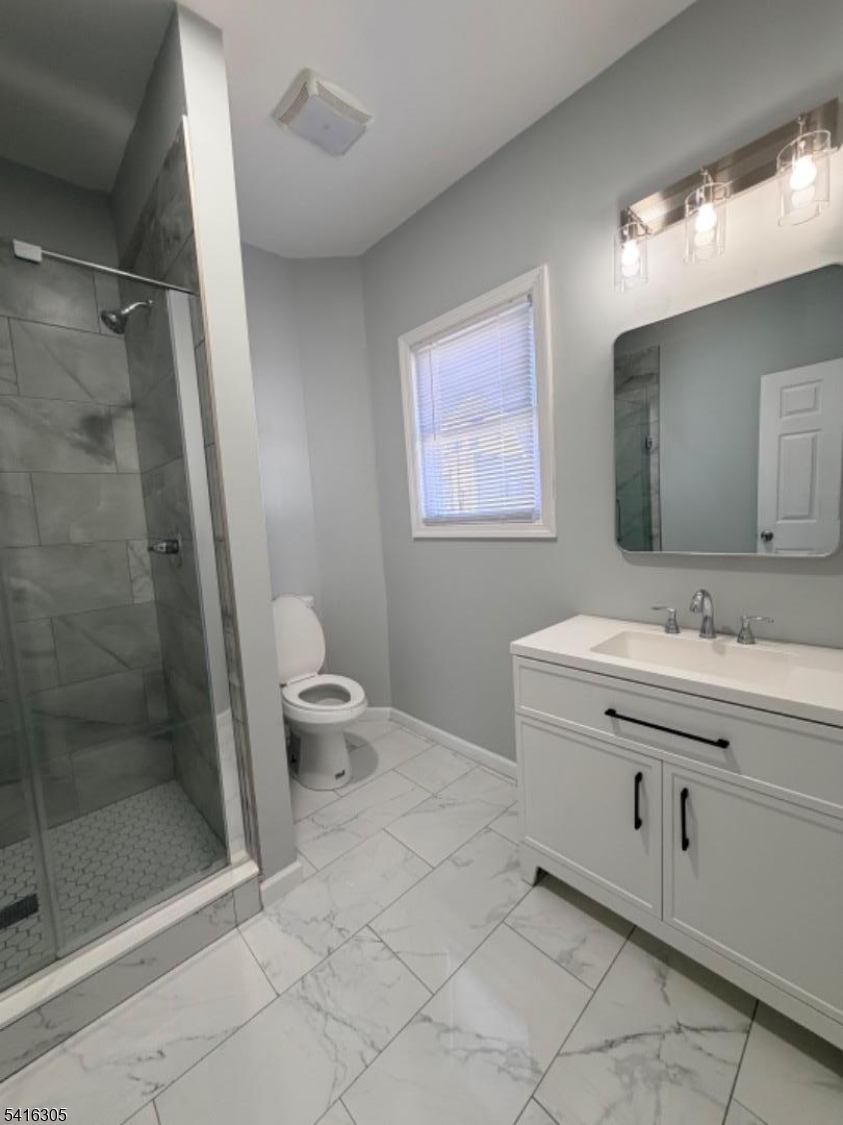 9 Oak Place Irvington, NJ 07111 - Photo 10 of 15 a bathroom with a double vanity sink mirror and toilet